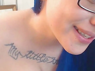 Closeup Squirt Blue Hair Punk Teen With Tattoos and Glasses